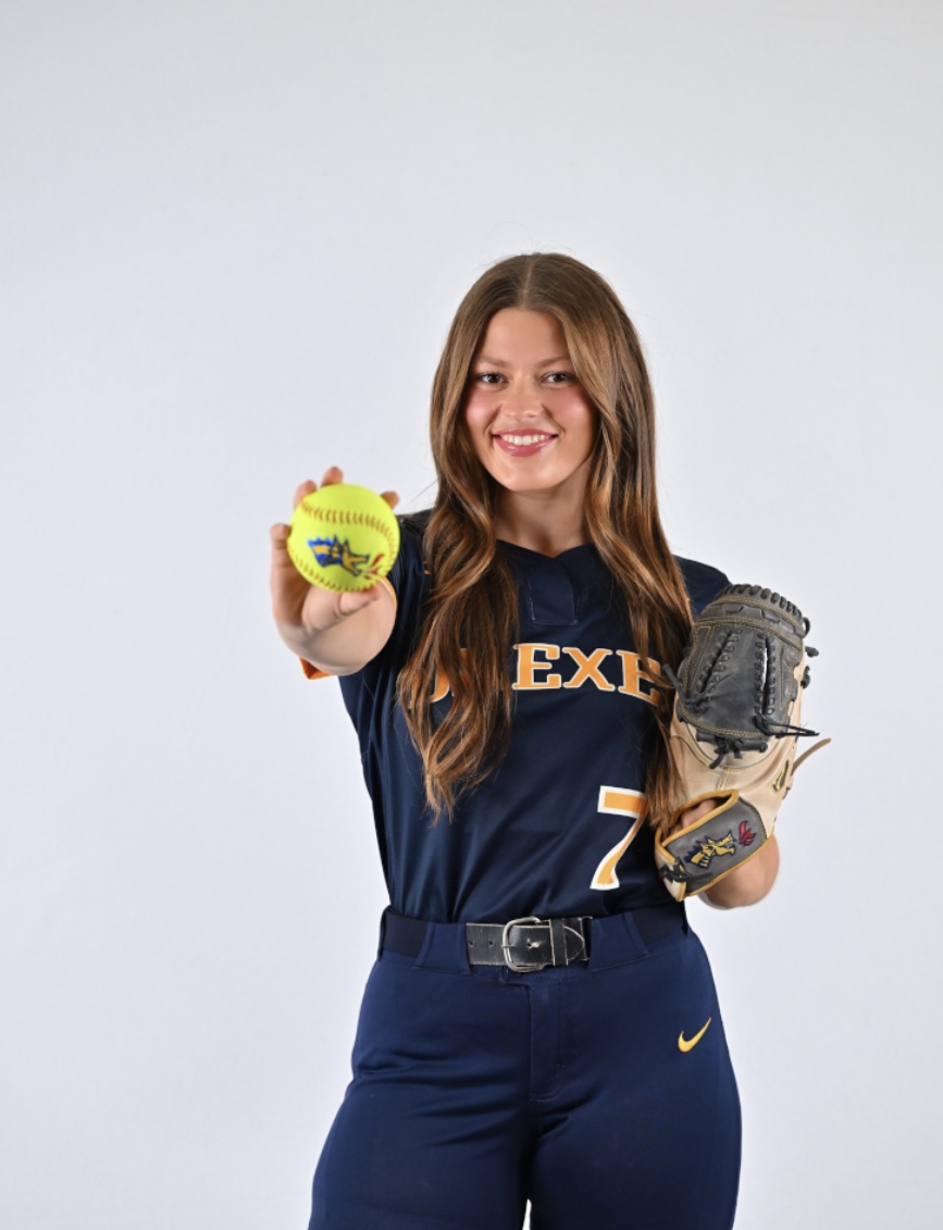 Kelcie Peters media day photos. Holding a softball and glove.